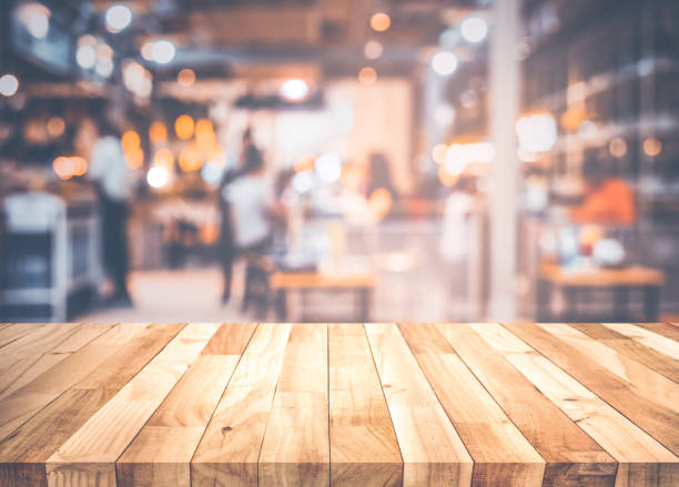 istock Empty wood table top on blur light bokeh in dark night cafe restaurant background 1186843117