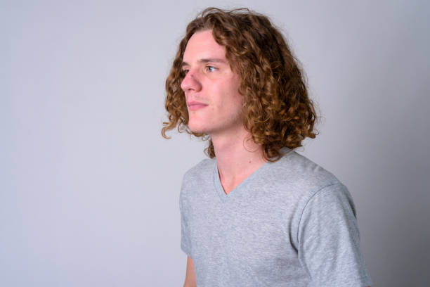 istock Face of young handsome man with curly hair thinking 1186844201