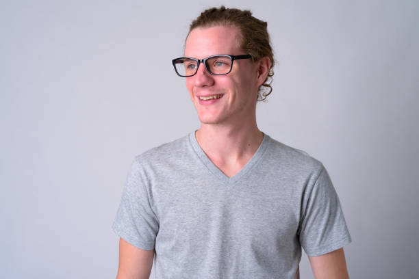 istock Face of happy young handsome man with eyeglasses thinking 1186844334