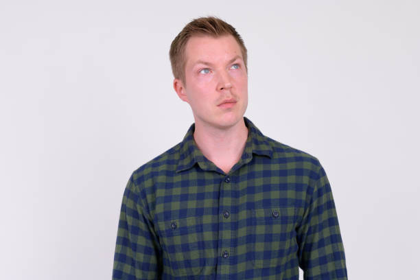 istock Young handsome hipster man thinking and looking up 1186845533