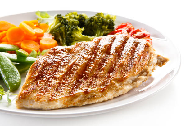 istock Grilled chicken breast with vegetable salad on white background 1186850396