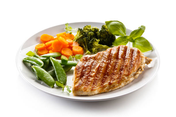 istock Grilled chicken breast with vegetable salad on white background 1186850415