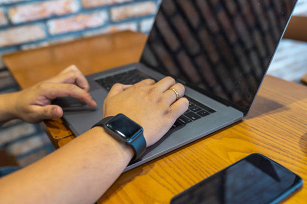 istock Human hand typing laptop keyboard on wooden table 1186851960