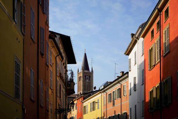 Narrow colourful alley on a sunny Winter day, Parma, Italy