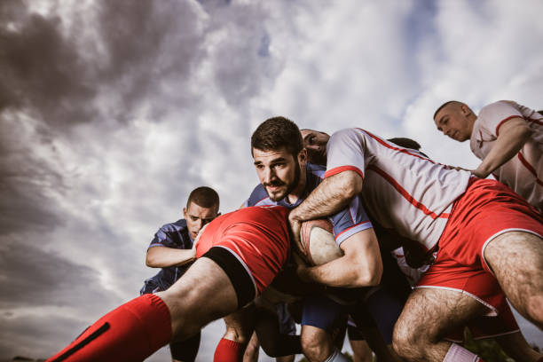 istock Rugby player making an effort while trying to pass rivals on a match.. 1186855371
