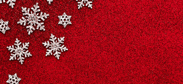 istock Merry christmas concept white snowflakes on red glitter background table minimal flat lay with red glitter, winter holiday party event card, horizontal photo design postcard banner, copy space 1186855631