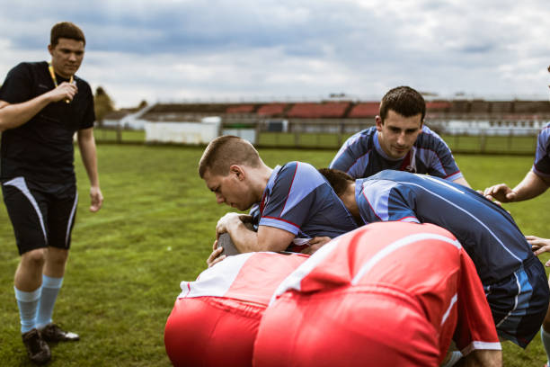 istock Young athlete making an effort during rugby match on playing field. 1186858383
