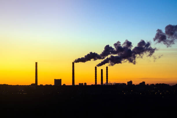 istock factories smoke from pipes at sunset 1186860018
