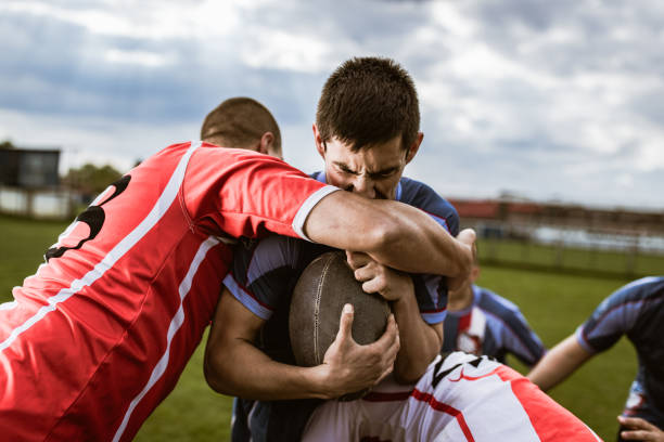 istock Rugby player making an effort while trying to pass rivals on a match. 1186860270