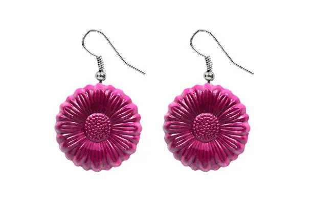 Pink plastic flower earrings on white background