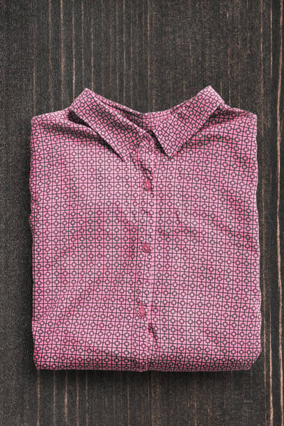 istock Shirt on wooden background 1186861946