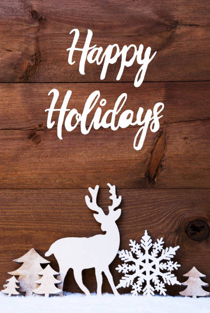 English Calligraphy Happy Holidays. Christmas Decoration Like Snowflake, Tree And Deer. Brown Wooden Background