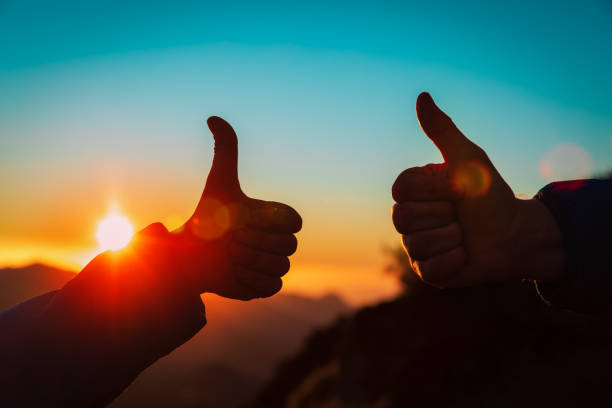 istock father and son thumb up in sunset mountains 1186866893
