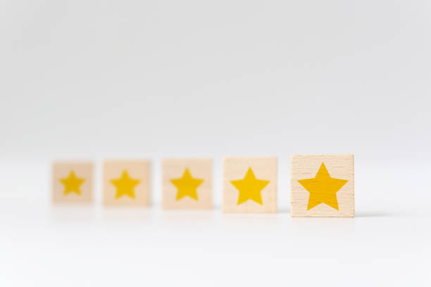 Wooden cube with five star shape on white background. The best excellent business services rating customer experience concept