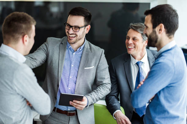 istock Team of happy businessmen communicating while using digital tablet. 1186873992