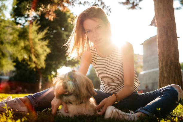 istock Woman with dog in a park 1186874993