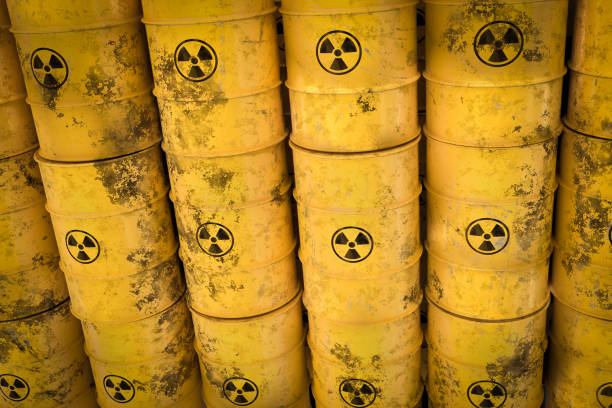 yellow radioactive waste barrels - nuclear waste dumping concept - nuclear weapons imagens e fotografias de stock