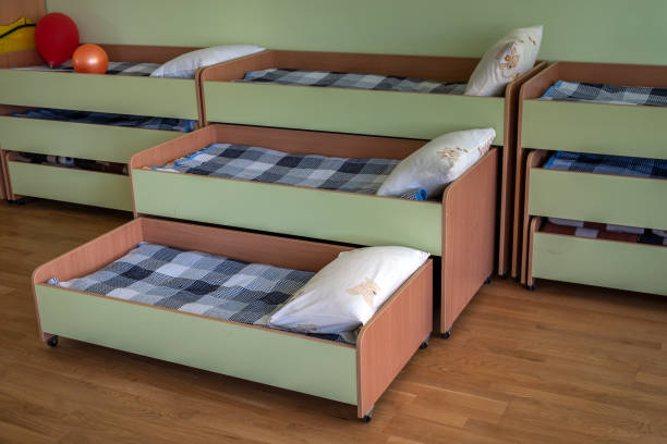 istock Many small beds in daycare preeschool empty bedroom. 1186877792