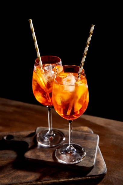 istock Spritz in glasses with straws on wooden chopping boards 1186878175
