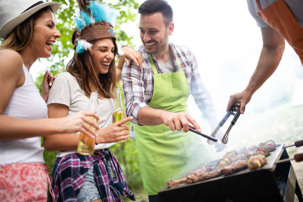 istock Friends having a barbecue party and fun in nature 1186879209