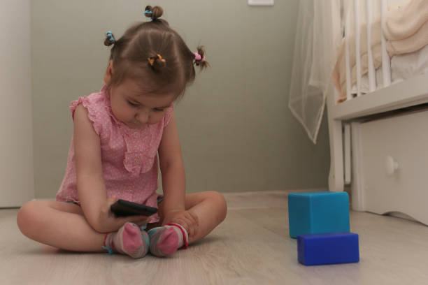 istock Young kid playing on a floor in a room 1186879463