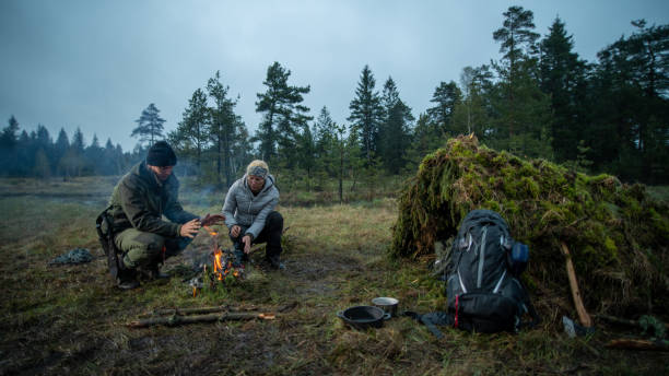 istock Couple sitting neat campfire 1186881172