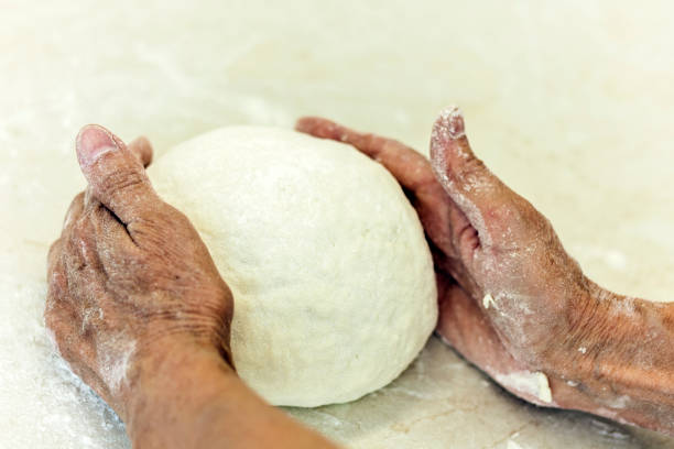 istock women's hands kneading making dough for dumplings 1186881233