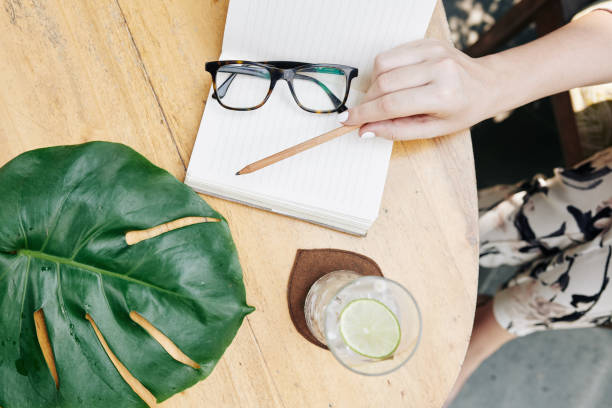 istock Woman filling gratitude journal 1186881416