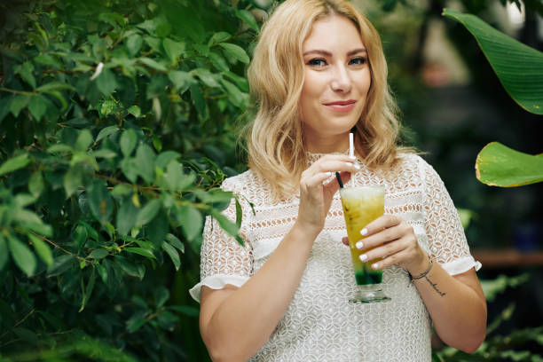 istock Woman drinking lime cocktail 1186881535