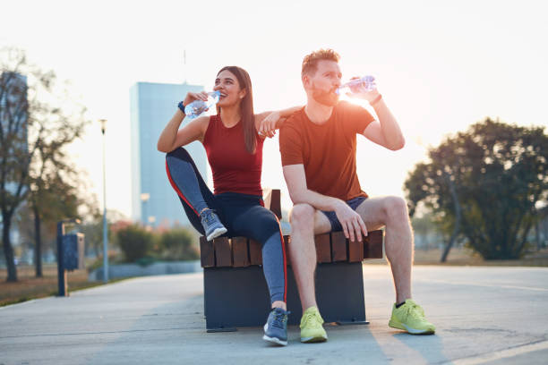istock Modern couple making pause in an urban park during jogging / exercise. 1186882826