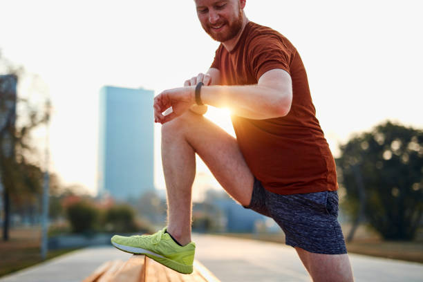 istock Young man exercising / stretching in urban park. 1186884199