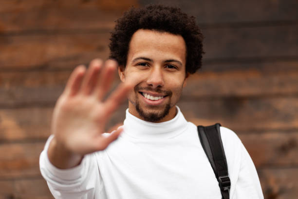 istock Friendly and joyful African man shows gesture of greeting 1186884268