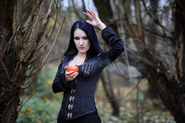 istock A woman in a witch suit in a forest 1186884591