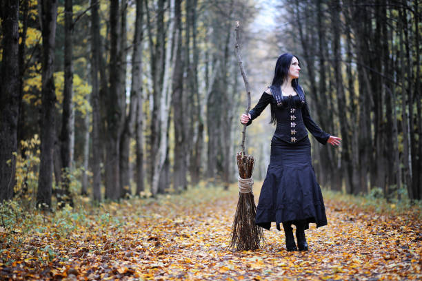 istock A woman in a witch suit in a forest 1186885283