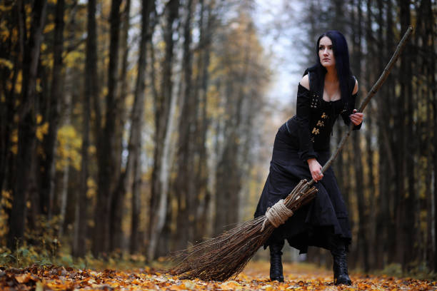 istock A woman in a witch suit in a forest 1186885306