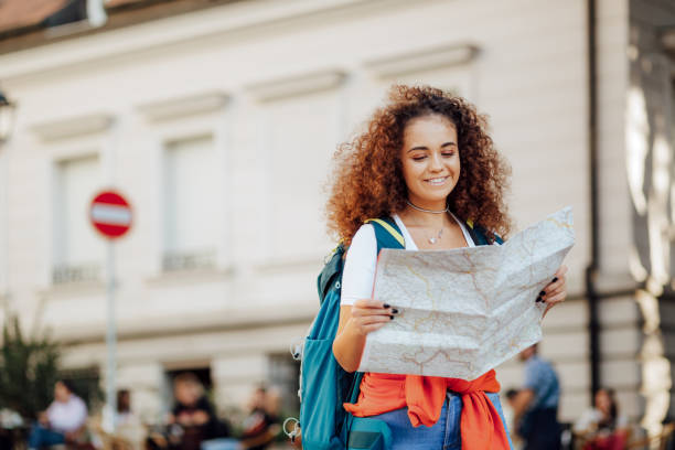 istock Pretty female tourist checking her bearings 1186885476