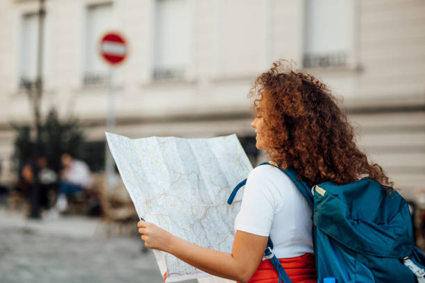 istock Pretty female tourist checking her bearings 1186885477