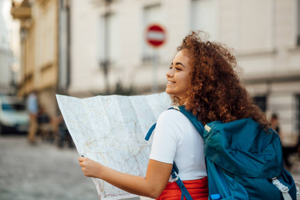 istock Pretty female tourist checking her bearings 1186885481