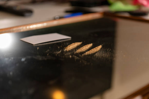 istock Man is Preparing a Lines of Drugs for Snorting 1186885710