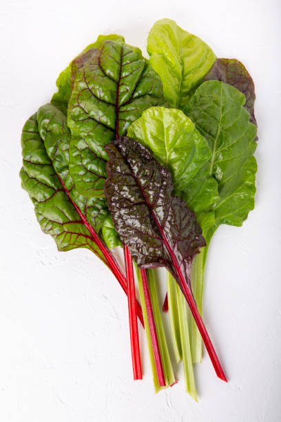istock Bunch of fresh chard leaves on white background. Top view. 1186887239