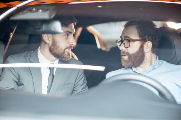 istock Sales manager with a client looking at the vehicle interior 1186888653
