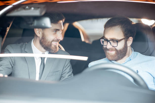 istock Sales manager with a client looking at the vehicle interior 1186888678