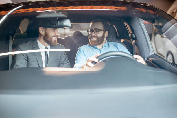 istock Sales manager with a client looking at the vehicle interior 1186888685
