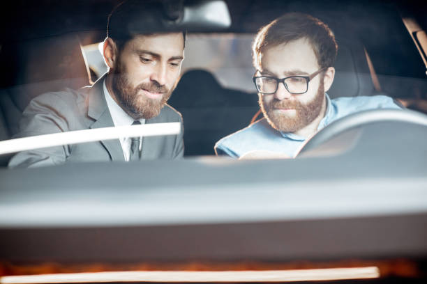 istock Sales manager with a client looking at the vehicle interior 1186888710
