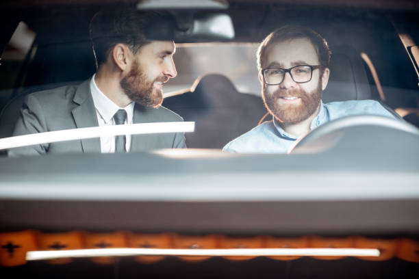 istock Sales manager with a client looking at the vehicle interior 1186888744