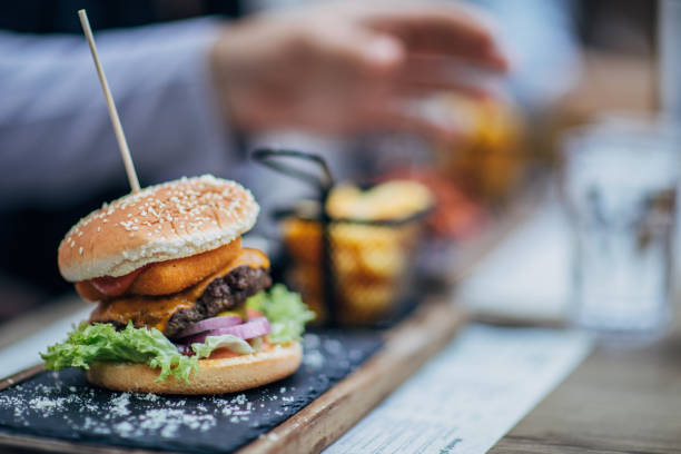 Burger on a plate outdoors in pub.