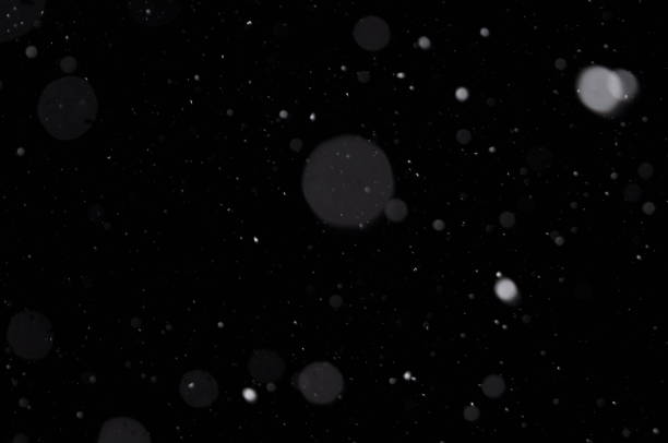 istock Overlay of real snow falling against the black night sky 1186893123