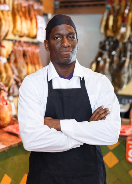 istock Confident shop owner near counter with ham 1186894259
