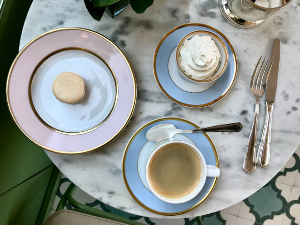 istock Macaroon / Macaron at Cafe Shop with Coffee and Cream served on Marble table. 1186894541