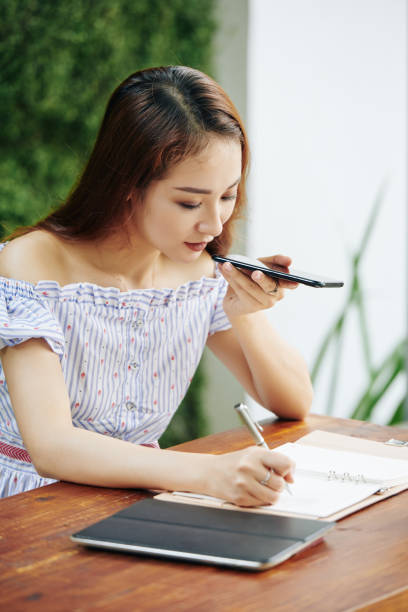 istock Business lady recording voice message 1186894813